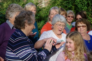 The W.I. Centenary Baton being handed round the Papworth Everard W.I. members and some grandchildren